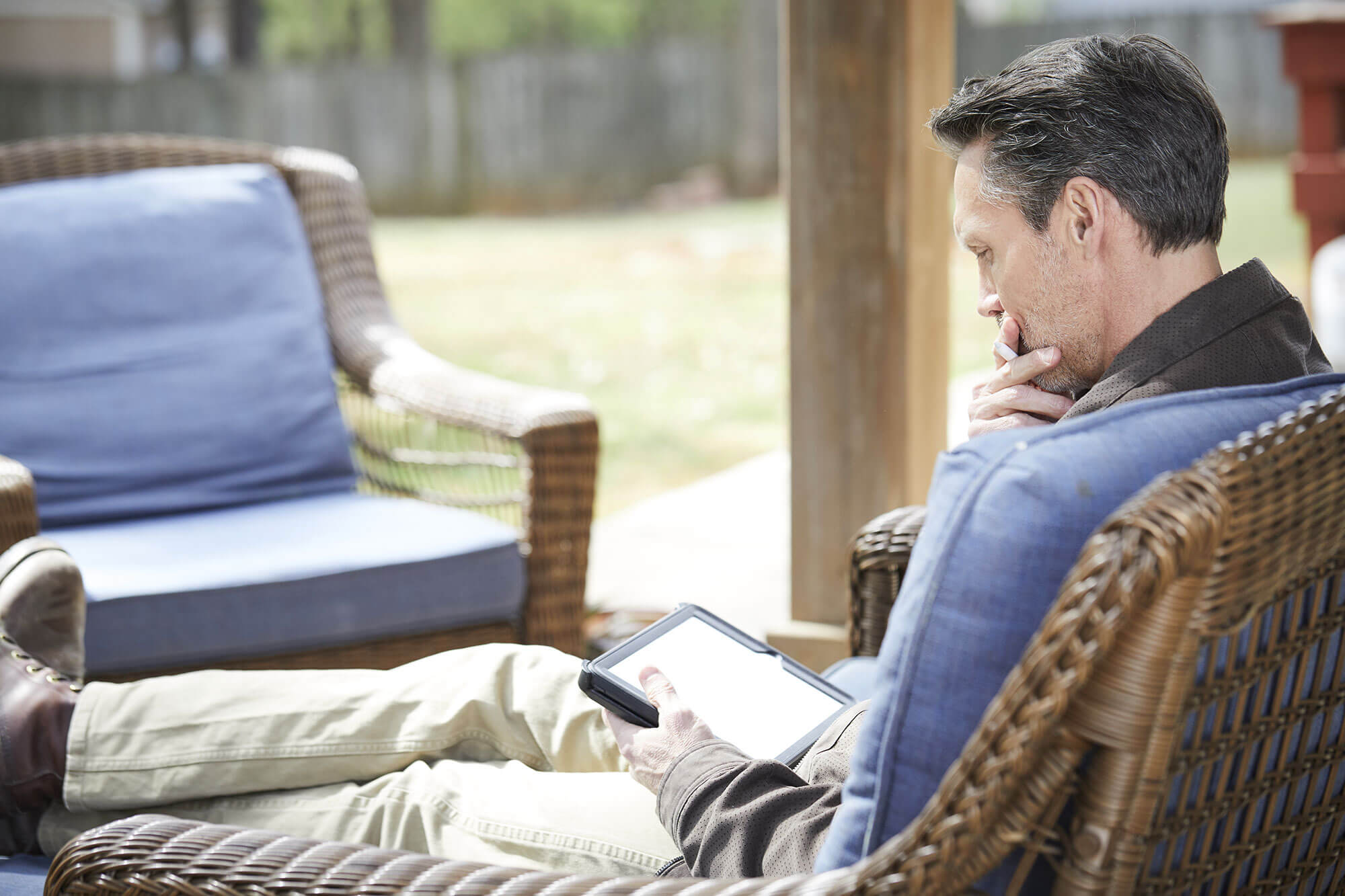 Thinking man reading his tablet